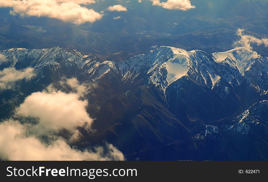 Aerial view of some mountains covered by snow and clouds. Aerial view of some mountains covered by snow and clouds.