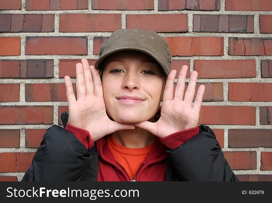 Woman with her hands up to her face. Woman with her hands up to her face