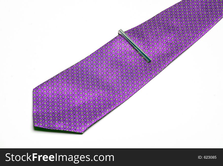 Pink necktie with needle on white background