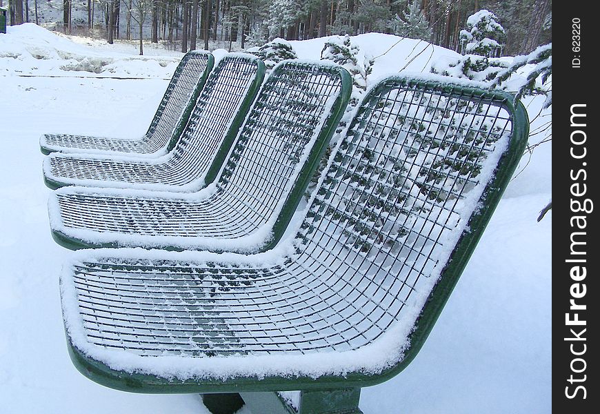 Bench covered with snow