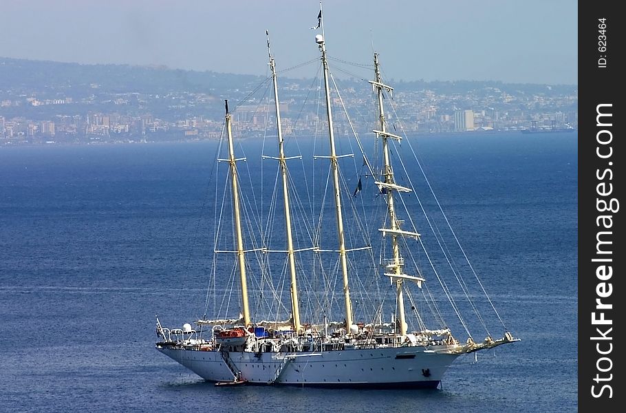 Large sailboat anchored off the Amalfi coast with Naples in the background