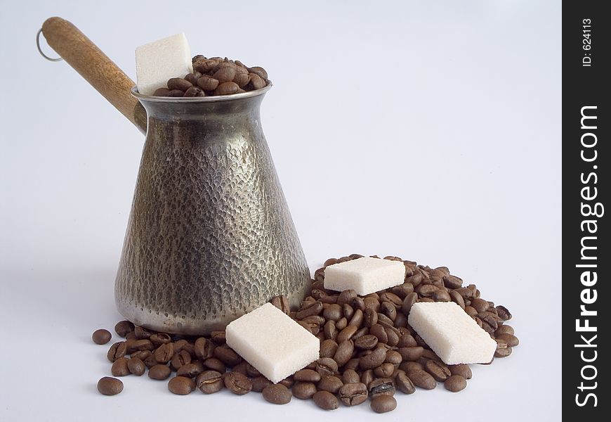 Cezve and coffee beans and refined sugar. Cezve and coffee beans and refined sugar