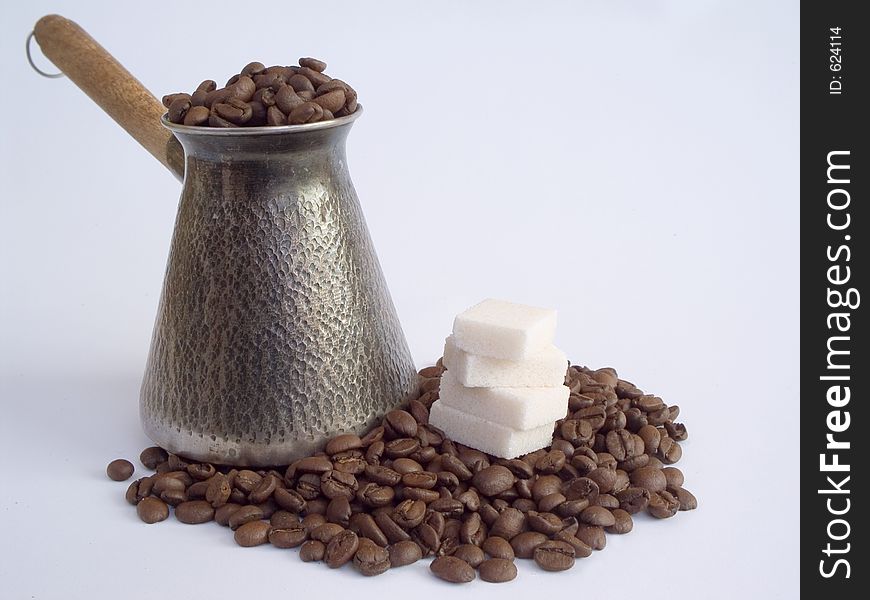 Cezve and coffee beans and refined sugar. Cezve and coffee beans and refined sugar