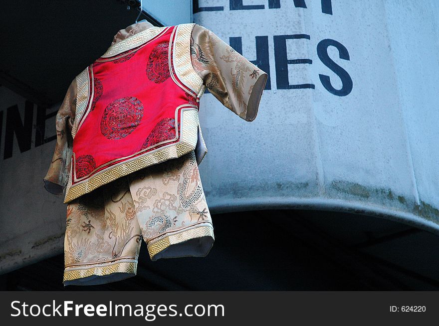 Little chinese boy's outfit hanging outside of china town. Little chinese boy's outfit hanging outside of china town