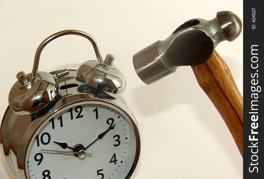 Annoying alarm clock threastened by rampant hammer. Annoying alarm clock threastened by rampant hammer