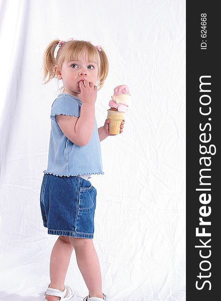 A girl holding an ice cream cone. A girl holding an ice cream cone.