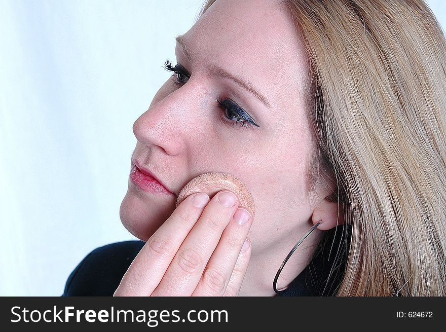 A woman applying make up. A woman applying make up.