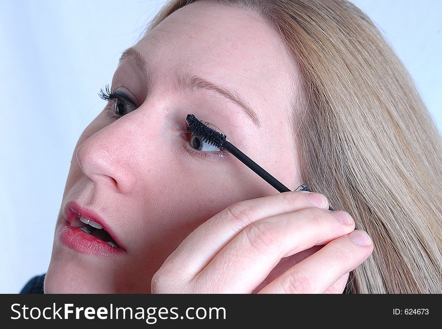 A woman applying make up. A woman applying make up.