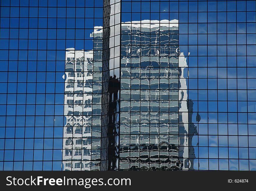 Reflection of one skyscraper in a glass wall of another one. Reflection of one skyscraper in a glass wall of another one.