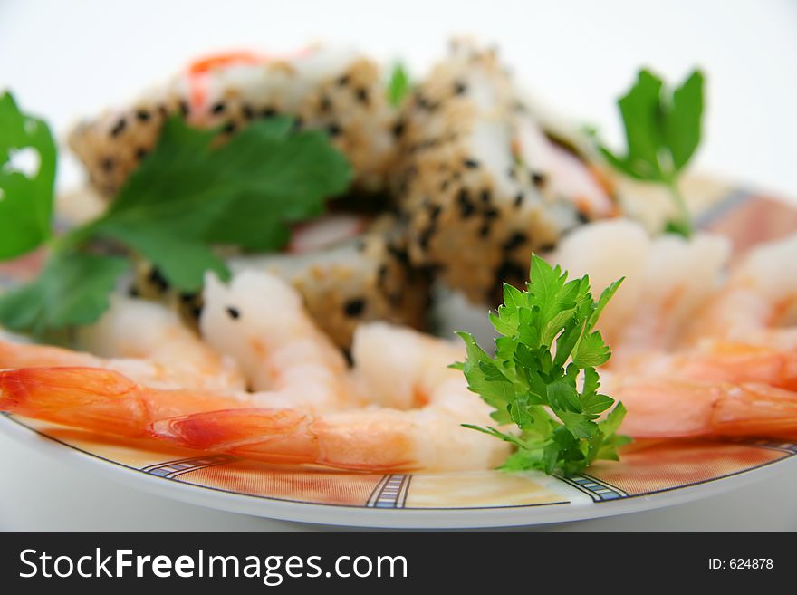 Plate with sushi rolls and shrimps. Shallow depth of field. Plate with sushi rolls and shrimps. Shallow depth of field.