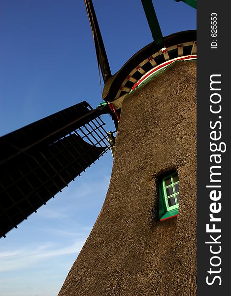 A windmill in motion in Zaanse Schans, Netherlands. A windmill in motion in Zaanse Schans, Netherlands.