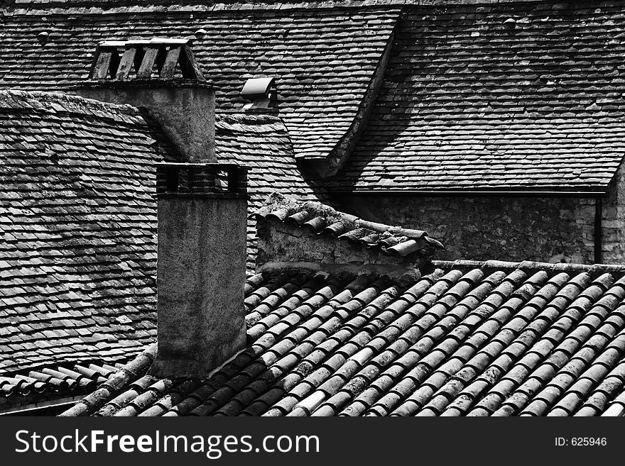 View of old tiled rooftops in the ancient French town of Vezelay. View of old tiled rooftops in the ancient French town of Vezelay.