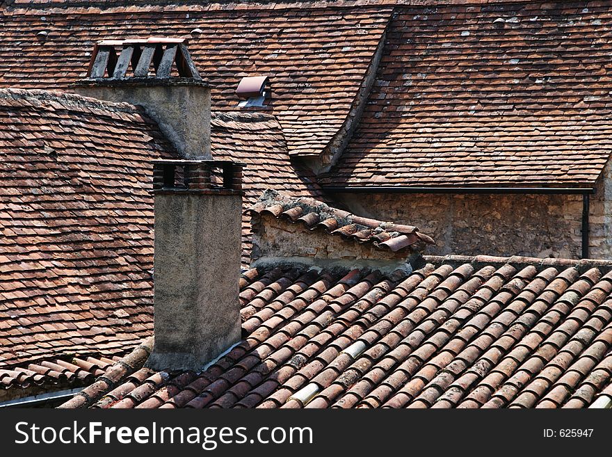 View of old tiled rooftops in the ancient French town of Vezelay. View of old tiled rooftops in the ancient French town of Vezelay.