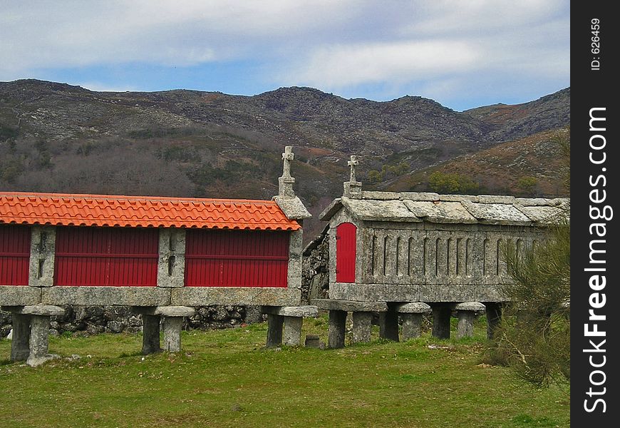 Two granaries on a country landscape