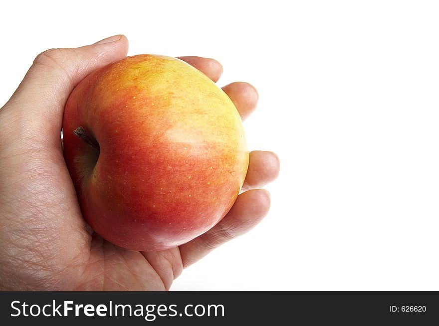 Red apple in a hand on a white background