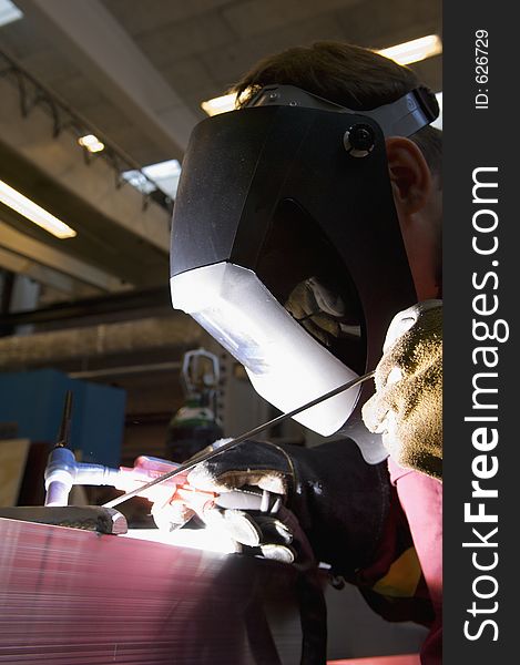 Welder at work with fine mechanics. Welder at work with fine mechanics