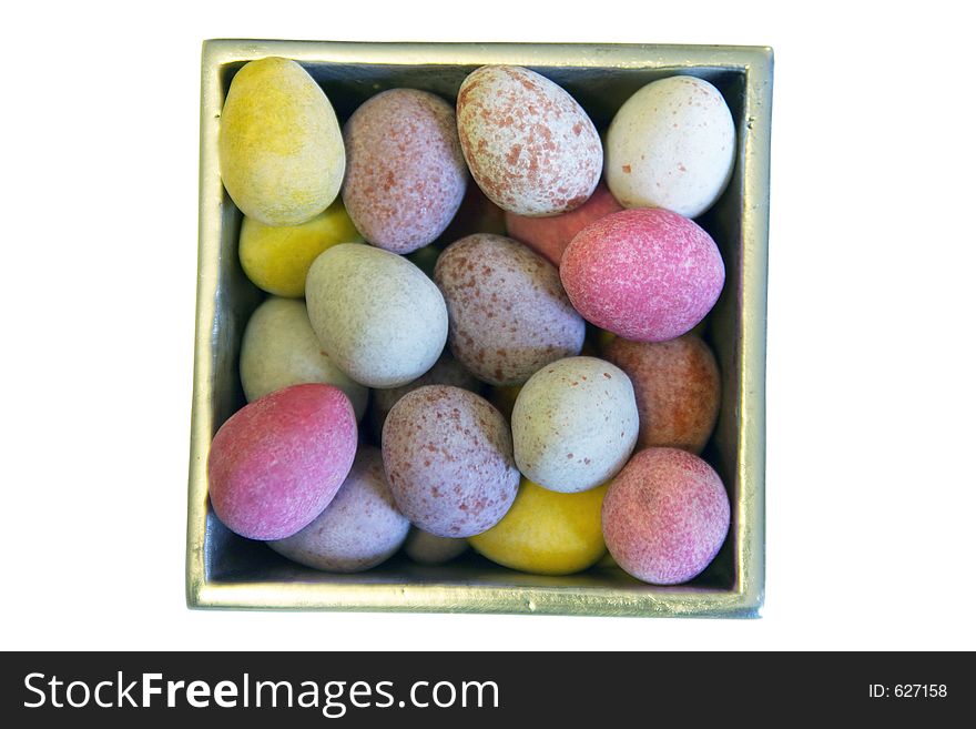 Mini candy chocolate eggs in a polished silver box (isolated)