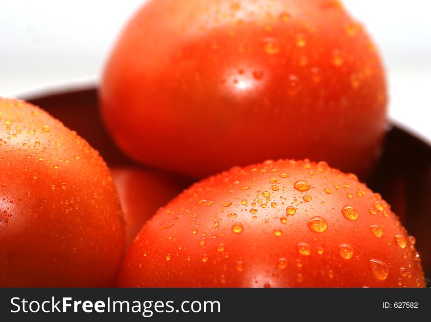 Cropped shot of tomatoes with drops of water on them. Cropped shot of tomatoes with drops of water on them