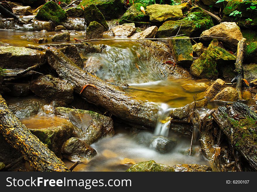 This is s shot of a creek and some rocks and  debris in it.