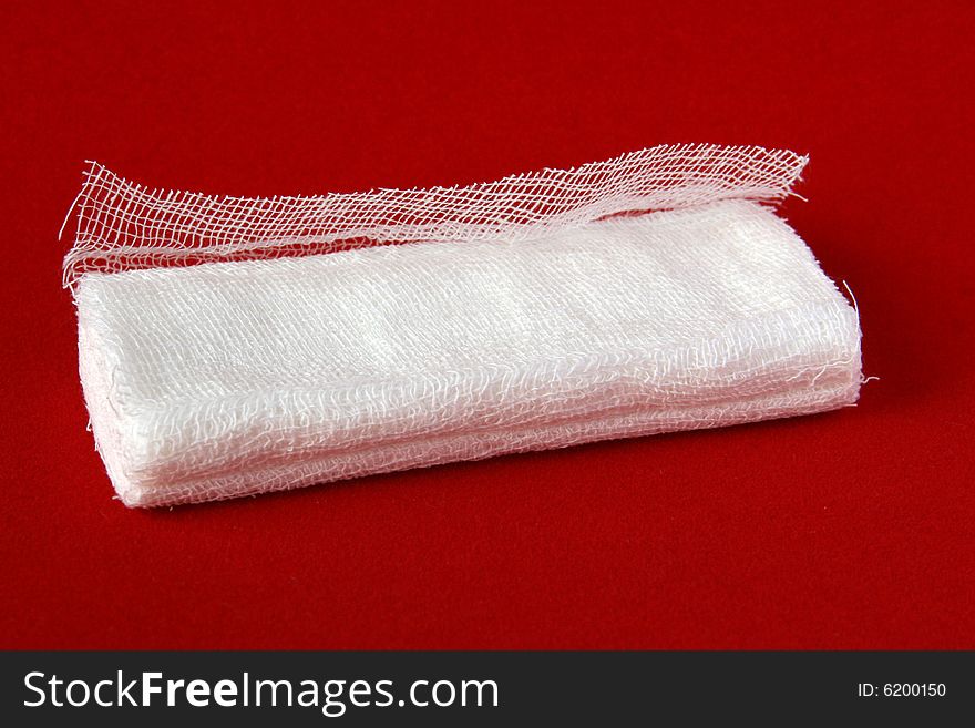 White medical gauze on red velvet background. White medical gauze on red velvet background