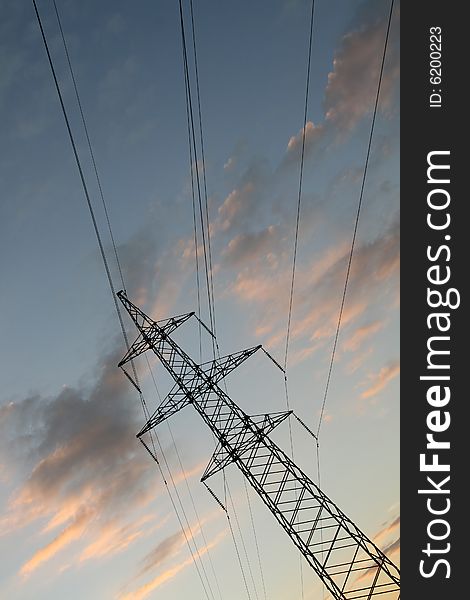 High-voltage transmission tower on sunset