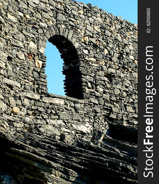 A beautiful shot of an open window in a ancient wall in Porto Venere. A beautiful shot of an open window in a ancient wall in Porto Venere