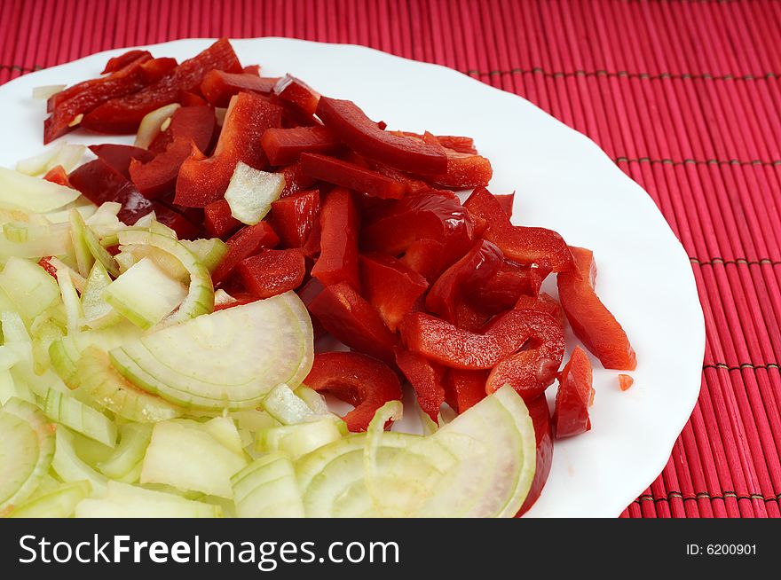 Red Pepper And Onion On Bamboo