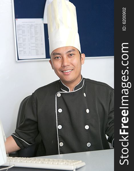 Chef in office with computer