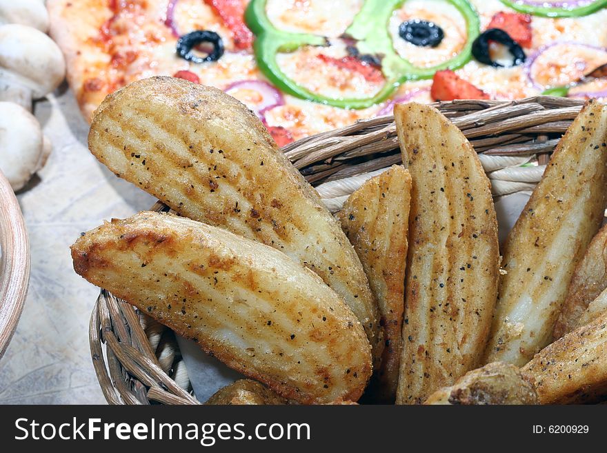 Close up of spicy potato wedges in a basket