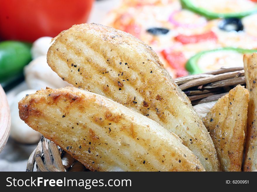 Close up of spicy potato wedges in a basket