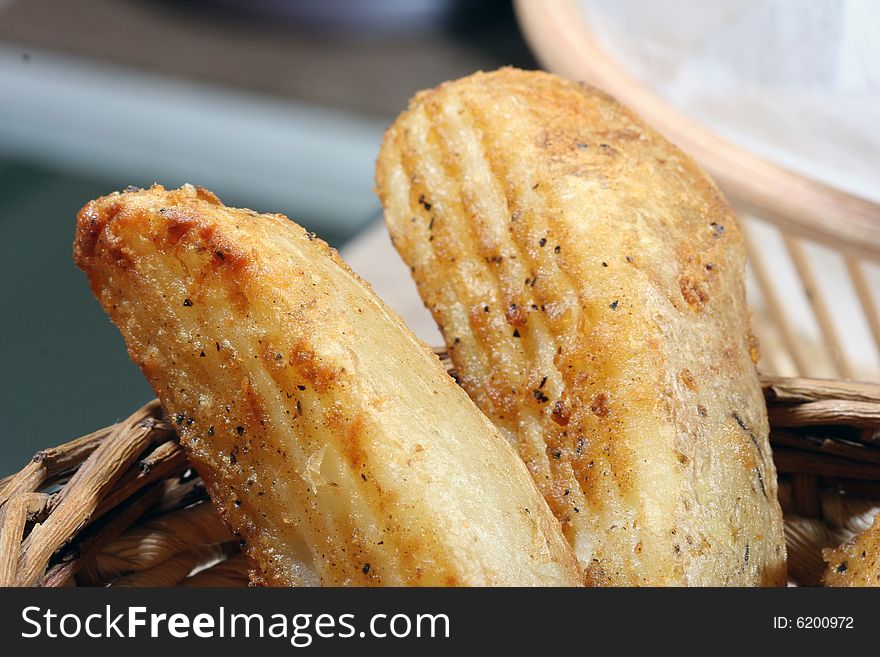Close up of spicy potato wedges in a basket