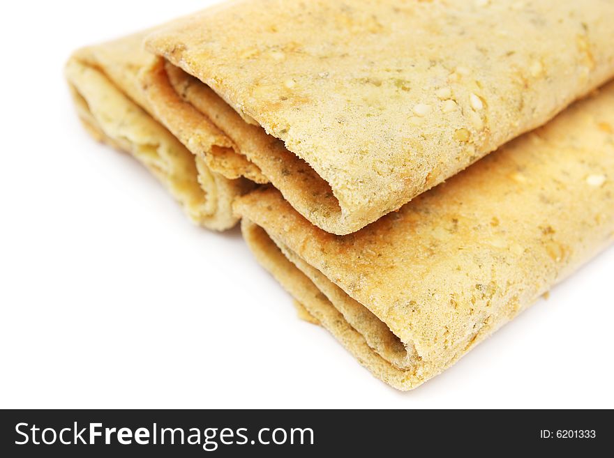 Three eggroll biscuits stacked together on white background.