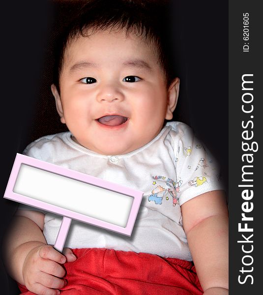 A cute and chubby baby is holding a placard that you can write anything on it. A cute and chubby baby is holding a placard that you can write anything on it