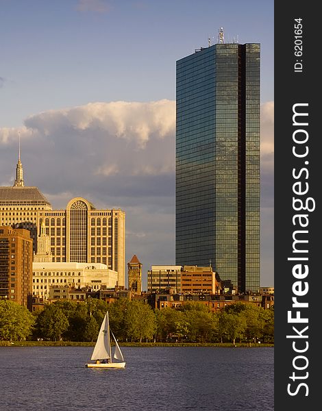 A sailboat on the Charles River glides by the Hancock Tower in Boston's Back Bay area. A sailboat on the Charles River glides by the Hancock Tower in Boston's Back Bay area