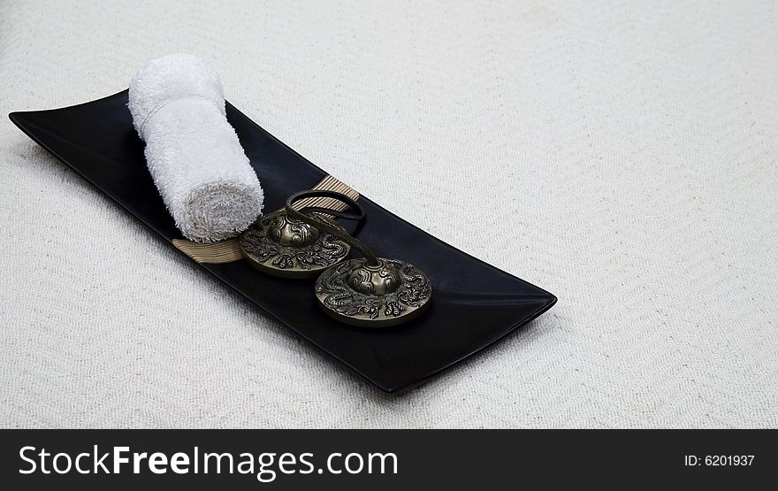 Oriental styled spa accesories over a white cloth