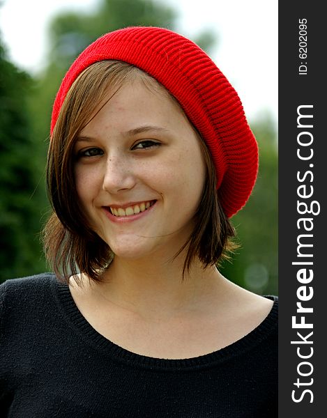 Portrait of a young girl with red cap.