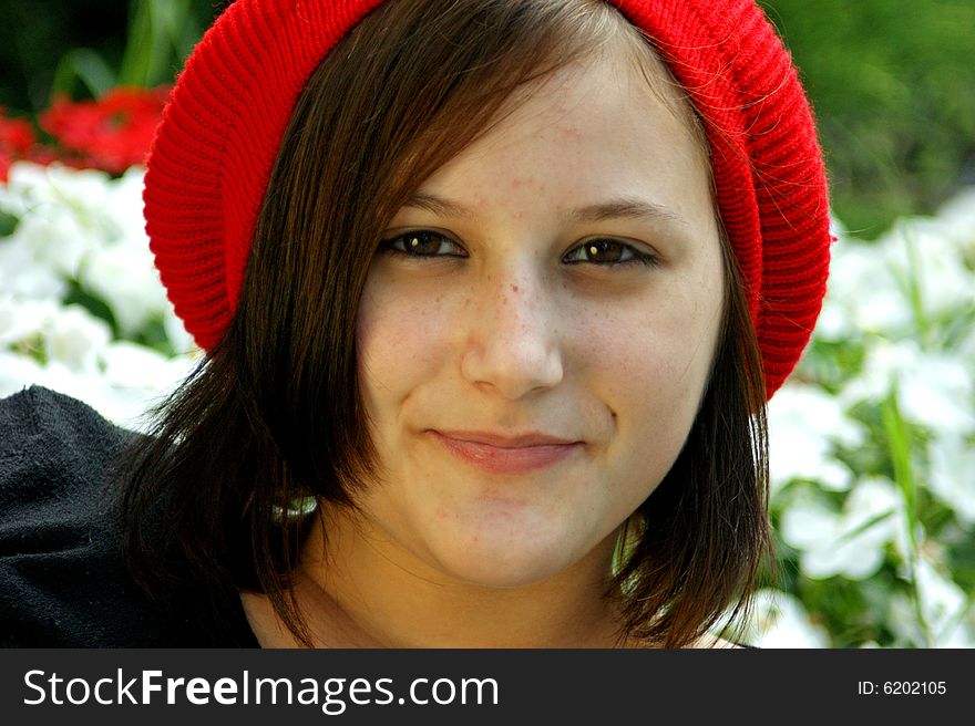 Portrait Of A Young Girl With Red Cap.