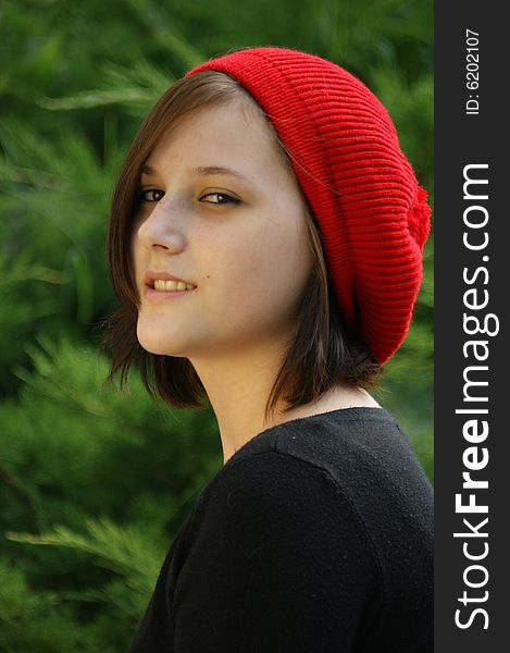 Portrait Of A Young Girl With Red Cap.