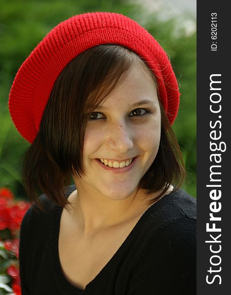 A portrait of a young girl with red cap.