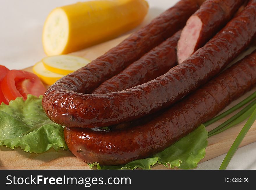 Delicious sausage and vegetables on the chopping board