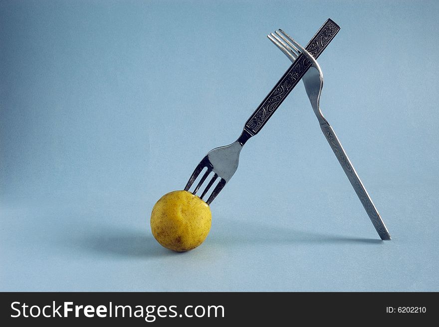 Still life with spoon on blue background. Still life with spoon on blue background.