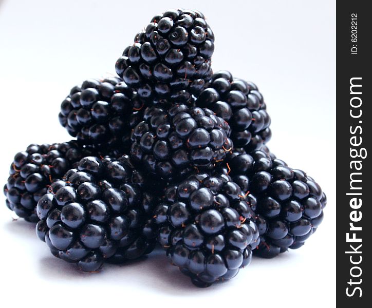 Blackberry on a white background, pyramid from black berries