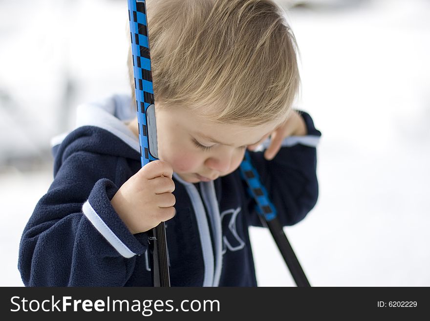 Small boy with sticks on the bright background