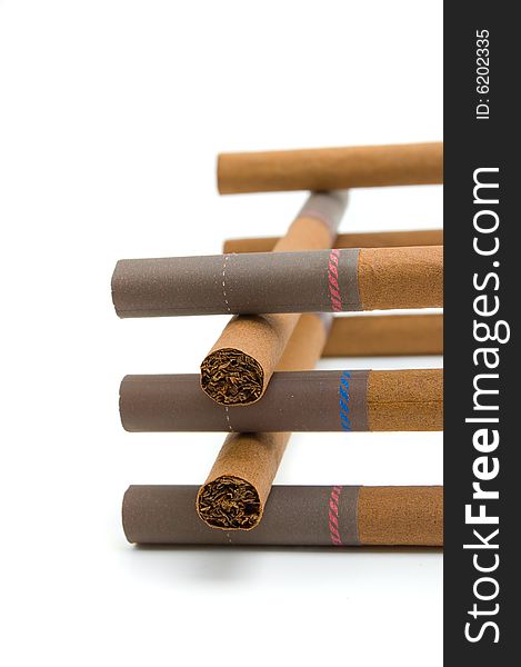 Little brown cigars (cigarettes) in a stack isolated on white background. Little brown cigars (cigarettes) in a stack isolated on white background