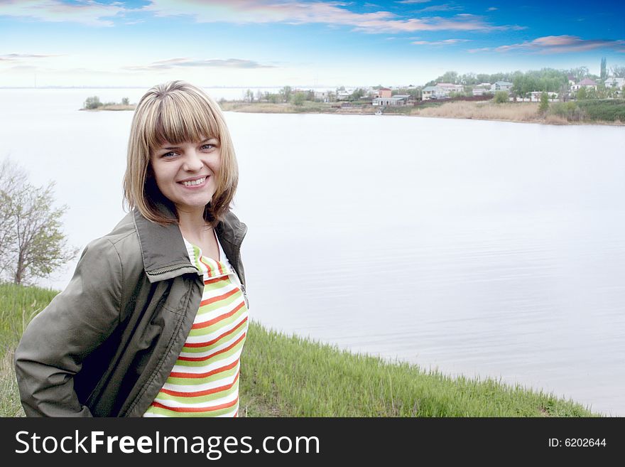 Beautiful making look younger woman on background of the rural river landscape. Beautiful making look younger woman on background of the rural river landscape