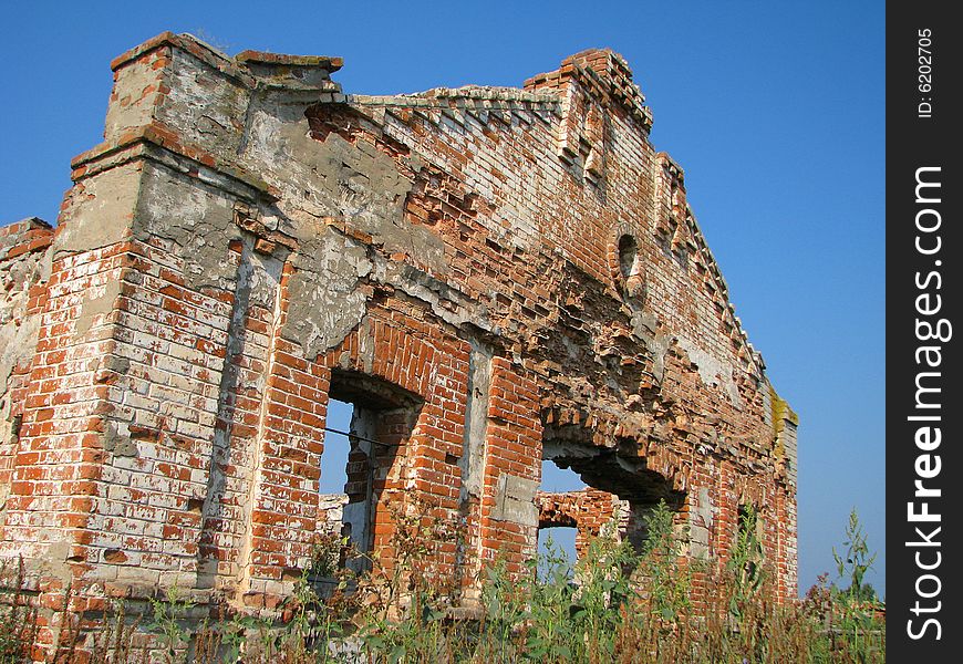 Old ruins of a brick building (farm) in village