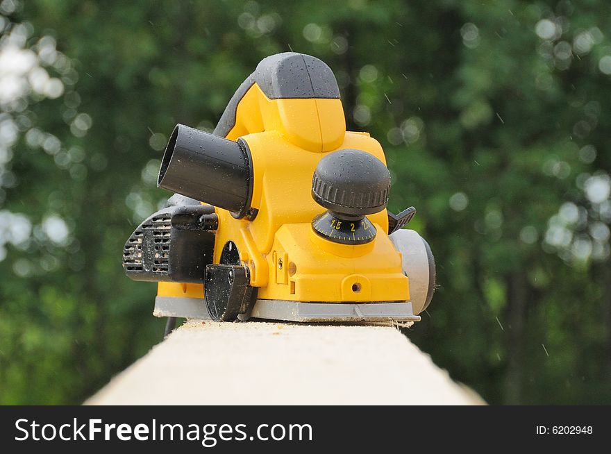 The modern yellow electric planer. The modern yellow electric planer