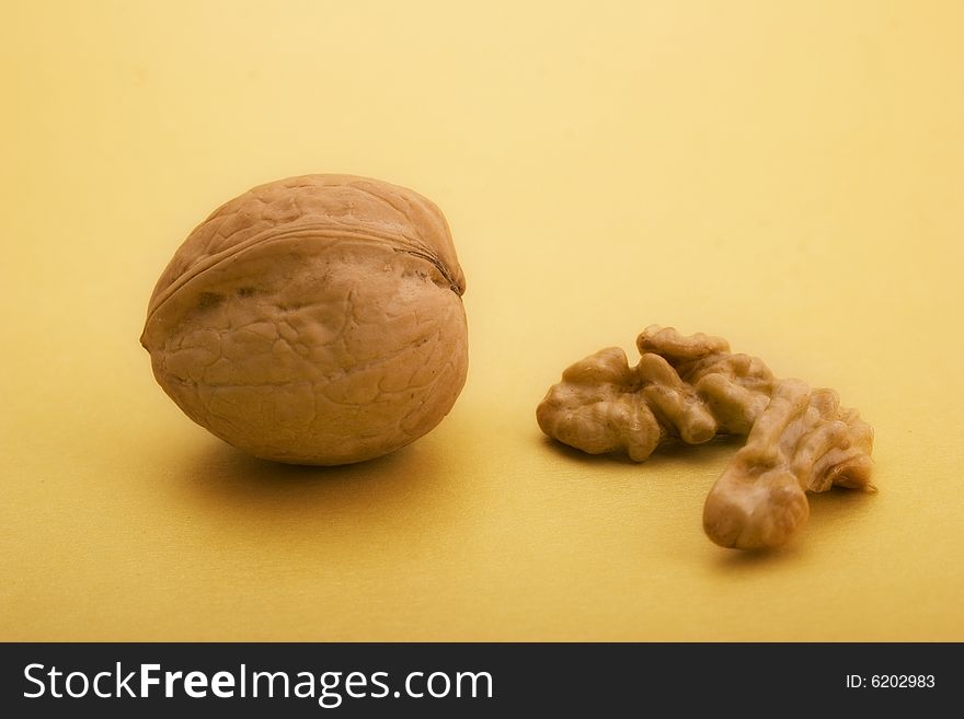 Walnuts close-up on the beige background. Walnuts close-up on the beige background