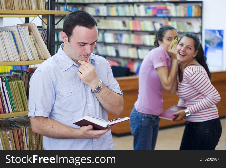 Three students in library