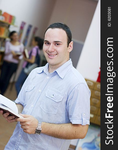 Young student holding book and reading